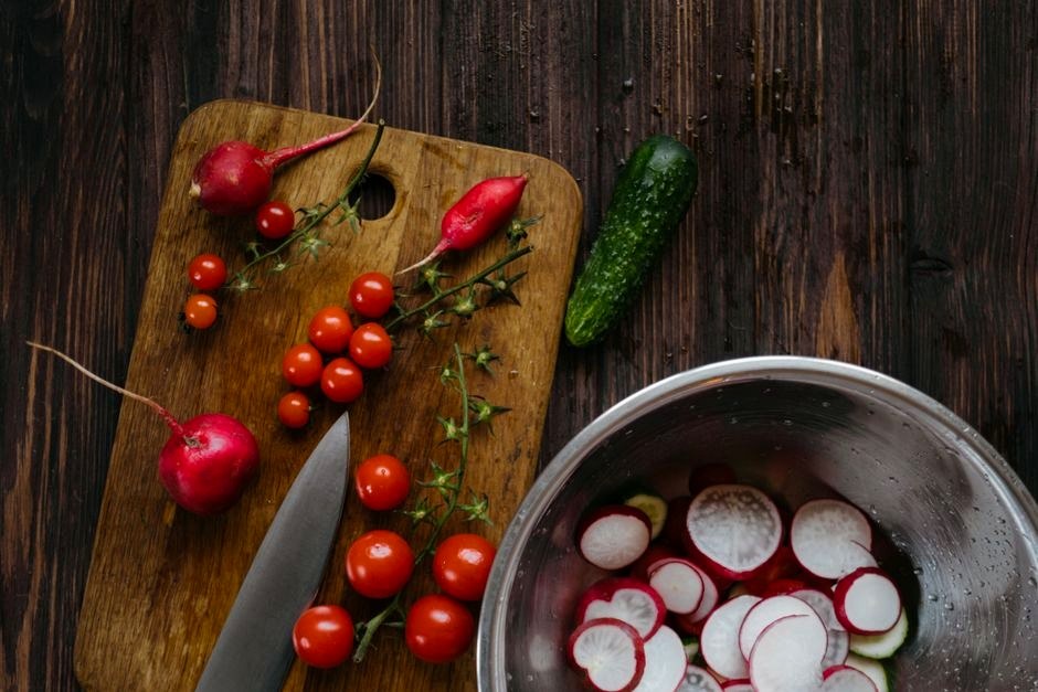 Radishes and fresh vegetables prepared for quick pickling.